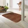 Morland cotton doormat in colour cinnamon on on a wooden floor in a bright room by a bowl of fruit
