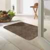 Morland cotton doormat in colour coffee on on a wooden floor in a bright room