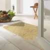 Morland cotton doormat in colour latte on on a wooden floor