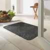 Morland cotton doormat in colour slate on on a wooden floor in a bright room by a bowl of fruit