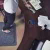 Woman at a desk standing on a Morland Comfort office anti-fatigue mat