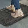 Close up of feet in boots standing on a Morland Comfort office anti-fatigue mat