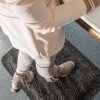 Woman at a standing desk on a Morland Comfort office anti-fatigue mat