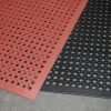 a black and a red Morland Industrial Rubber Doormat laid with the red mat at an angle on top of the black mat