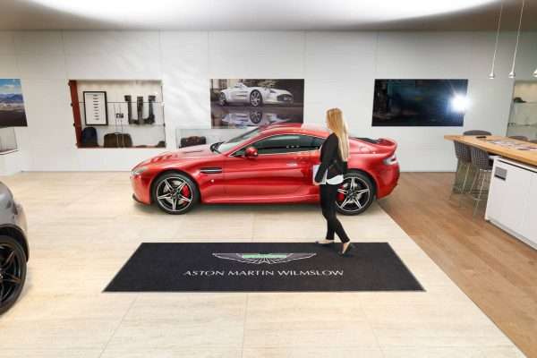 Large logo door mat in car showroom