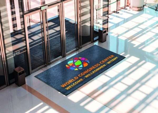 Large logo doormat by conference entrance door